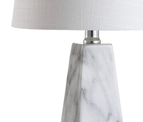 Close-up of White Marble Look Resin Table Lamp With Faceted Contemporary Design, cool bedside lamp showing base texture and linen shade.