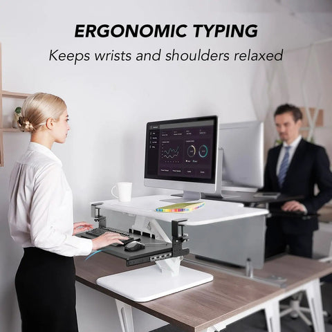 Under Desk Keyboard Tray Pull Out With Sturdy Adjustable C Clamp Mount System 32.5 Inch Clamp Span 27.3 Inch Platform By 11 Inch Slide Out For Typing Space Saver Black in use in office setting with woman typing