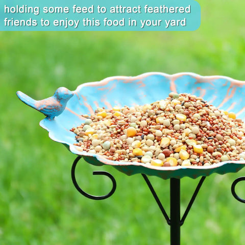 34 Inch Tall Metal Bird Bath On A Stake For Outdoors filled with bird seed, featuring a blue bird design and stable three prong base.