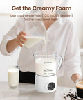 Person using 4 In 1 Milk Frother With Led Touch Screen And Ceramic Lined Bottom, 13.5 Oz Capacity with transparent glass, white