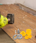 Safigle Electric Drill Pipe Threader Kit components including alloy dies on wood surface, with a hammer in a gloved hand.
