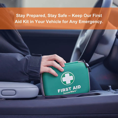 Person placing Ultra Compact 150 Piece First Aid Kit With Hard Shell in car, green case for travel and emergencies.