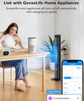 Person adjusting Smart Air Quality Monitor With PM2.5 Sensor, WiFi, Temperature And Humidity Tracking near home appliances.