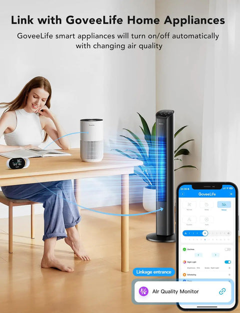 Person adjusting Smart Air Quality Monitor With PM2.5 Sensor, WiFi, Temperature And Humidity Tracking near home appliances.