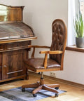 Heavy Duty Brass Finish Wooden Wheel Caster With Smooth As Silk Ball Bearings And Solid Steel Stem For Vintage Furniture Fix Ups That Handle Heavy Loads And Bring Back Old School Charm on a brown leather chair.