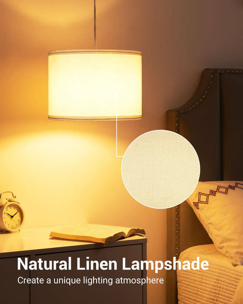 Plug In Pendant Light With 15 Ft Cord, On Off Switch, White Fabric Linen Shade emitting cozy glow above nightstand in bedroom.