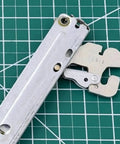 Top Shelf Wall Oven Door Hinge Set Built From Heavy Duty Silver Metal Compatible With Major Appliances detailed view on green cutting mat