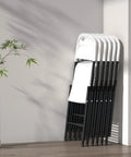 Stack of Built Tough 350 Pound Weight Capacity Plastic Folding Chairs With Reinforced Steel Frame in indoor setting