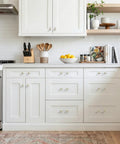 Modern kitchen with Five Pack Gold Acrylic Drawer Pulls With Brushed Brass Base, 3.75 Inch Center Hole, on white cabinets.