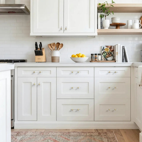 Modern kitchen with Five Pack Gold Acrylic Drawer Pulls With Brushed Brass Base, 3.75 Inch Center Hole, on white cabinets.