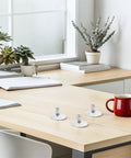 Heavy Duty Adjustable Furniture Leveling Feet on a desk with succulents, featuring a rock solid swivel base for stability.