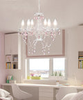 White Crystal Chandelier With Pink Droplets And Strands 6 Light Candle Style Ceiling Fixture For Bedroom Or Dining Vintage Glam Lighting With Elegant Scroll Arm Frame hanging in a bedroom with modern decor.