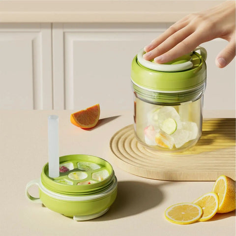 Hand pressing lid of 2 In 1 Ice Bottle Portable Ice Maker Hydration Gear with Leakproof Seal on table with citrus wedges