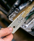 Hand holding 16 Beefy Nickel Plated Flush Cabinet Hinges, 2 Inch Butt Hinges For Drawer Wardrobe And Bathroom Doors in workshop