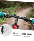Heavy Duty Mechanical Disc Brake Kit With Front And Rear Rotors And Thick Pads For Mountain Bike displayed on handlebars in forest.