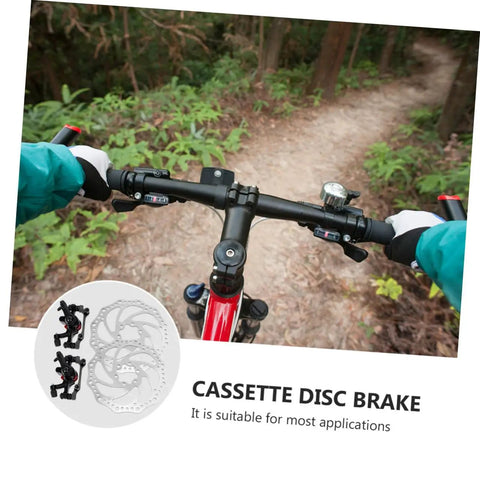 Heavy Duty Mechanical Disc Brake Kit With Front And Rear Rotors And Thick Pads For Mountain Bike displayed on handlebars in forest.