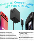 Fast USB-C Charger For Nintendo Switch With USB-C Cord, Compatible With Switch OLED, Switch Lite, And Steam Deck, Powers TV Mode Dock, High Output For Smooth Console Play On Big Screen. Black wall charger with USB-C cord beside Switch OLED and Steam Deck