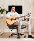 Man playing guitar on Ergonomic High Back Gaming Chair With Smooth Wheels For Long Hours Heavy Duty Desk Office Chair