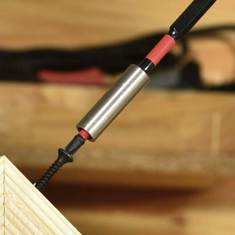 Close-up of a metal magnetic bit holder with a red and black Torx T25 bit inserted