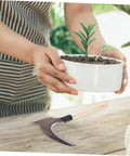 Multipurpose Manganese Weeding Scythe With Comfortable Handle Durable Garden Tool on table near potted plant