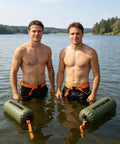 Two men holding Do It All 3 In 1 Inflatable Water Weight Bag For Camping, Swim Float And Tent Anchor, 10L green in a lake