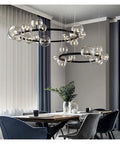 Fresh Modern Metal Chandelier with 39 Clear Glass Bubbles and G9 Sockets stylishly illuminating a dining area with black accents.