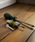 Top Shelf Furniture Connector Hardware Kit With Cam Lock Bolts And Sturdy Dowel Pins Made From Tough Alloy Iron For Seamlessly Joining Tables Dressers Wood Panels During A No Sweat Diy Build Day, with tools on wooden floor.