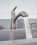 Parkwood Single Handle Pullout Kitchen Faucet With Dual Sprayer Aerated Stream Or Spray Stainless Finish ADA Compliant 120 Degree Swivel Spout Fits Single Hole Install Optional Deck Plate RP100681SS flowing water into sink