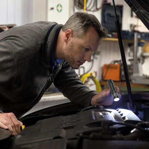 Mechanic uses 6 Pack LED Aluminum Mini USB C Rechargeable Handheld Flashlights for engine inspection.
