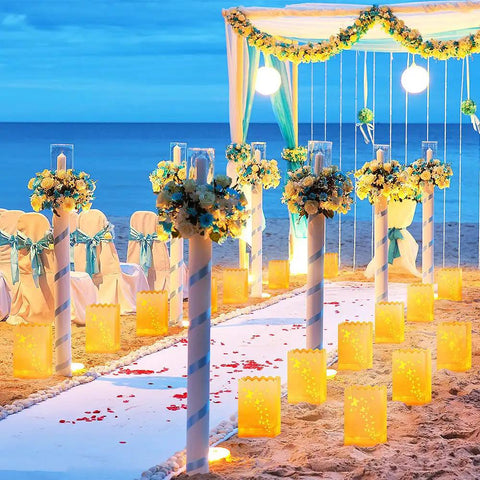 Sea-side wedding aisle lit with Lit Butterfly Luminary Bags And Flameless LED Tealights Set Of 50 Each White Outdoor Lanterns.