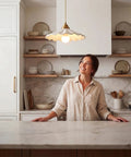 Premium White Scalloped Ceramic Pendant Light Adding Sweet Vintage Charm To Kitchen Islands, hung over a marble countertop.