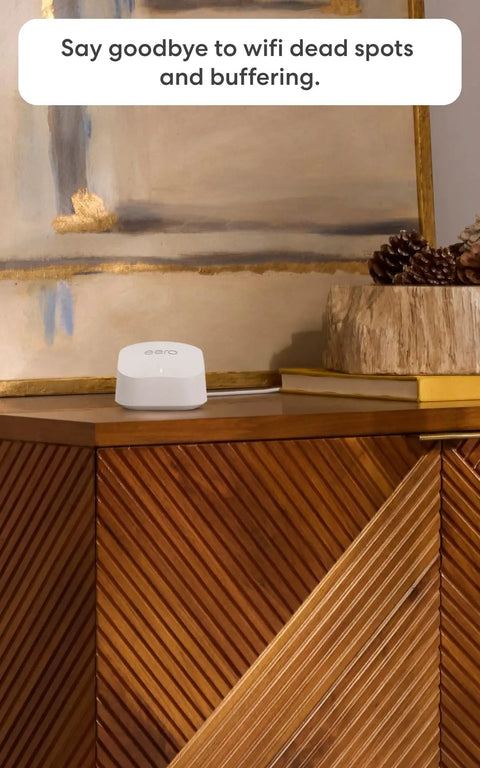 Budget Friendly Mesh WiFi System With Gigabit Speeds And WiFi 6 Plus Coverage Up To 4,500 Sq Ft Connect 75+ Devices 3 Pack Easy Setup For The Whole Home on a wooden cabinet.