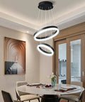 Elegant dining area with Two Ring Modern LED Chandelier In Black, Sleek Contemporary Ceiling Pendant Light For Staircase, Foyer, High Ceilings Or Living Room, 6000K Cool White, Dimmable And Adjustable Pendant Lighting.