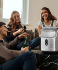 Three friends enjoying drinks next to Countertop Nugget Ice Maker With Chewable Pellet Ice 34 Lbs Per 24 Hours Self Cleaning