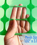 Close-up of green mesh from Extra Strength Plastic Fence With Stakes 40 Inch By 100 Foot Roll Green Heavy Duty Temporary Fence.