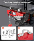 VEVOR electric hoist with red housing mounted to an I-beam using twin steel clamps; wired remote control and lifting chain visible.