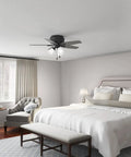 42 Inch Indoor Ceiling Fan With LED Light Kit, Matte Black, 5 Blade, Low Profile Flush Mount in bedroom setting, pull chain visible
