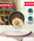 Mini Pan Set Two Piece Five Point Five Inch Nonstick Egg Pan With Spatula showing perfect egg frying, cool touch handle.