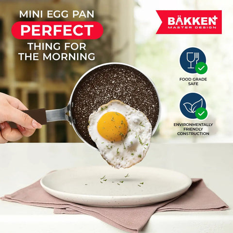 Mini Pan Set Two Piece Five Point Five Inch Nonstick Egg Pan With Spatula showing perfect egg frying, cool touch handle.