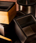 Stainless Steel Espresso Knock Box Heavy Duty Puck Disposal Bin With Welded Rubber Bar, pile of bins and cleaning brush