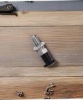 Rock Solid Stainless Steel Spring Plunger With Integrated Reset Mechanism And Precision Fine Thread for workbenches on wood background.