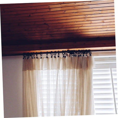 10 Pack Metal Curtain Rings With Clips Rustproof Hanging Curtain Hooks for Drapes on a wooden rod in modern home
