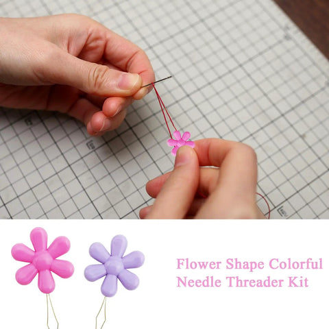 Hands threading needle with a pink petal-shaped threader from the 40 Piece Dope Petal Shaped Needle Threader Set In Assorted Colors For Hand Sewing, Cross Stitch, And Clothes Repair, Colorful Threader Kit For Mending, Jewelry Making, Quick Threading And Easy Craft Projects.