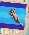 Oversized Beach Blanket 78 By 81 Inches Go-To Picnic Mat For 4 To 7 Adults Waterproof And Sandproof on beach by water and flip-flops.