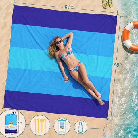 Oversized Beach Blanket 78 By 81 Inches Go-To Picnic Mat For 4 To 7 Adults Waterproof And Sandproof on beach by water and flip-flops.