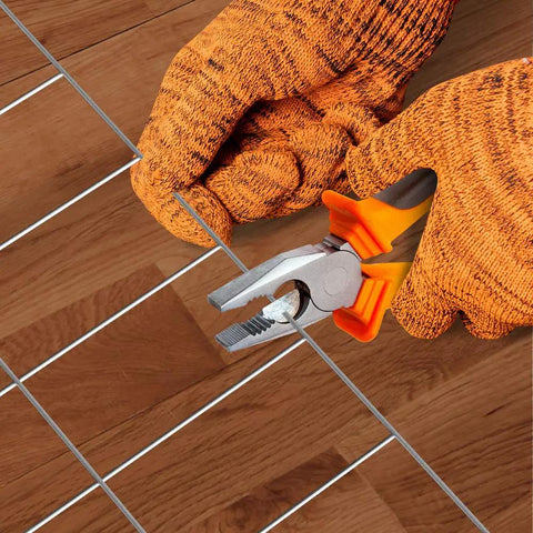 Gloved hands cutting Welded Wire Fence Roll 36 Inch By 50 Foot Galvanized Hardware Cloth 14 Gauge Mesh with pliers for installation.