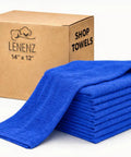 Stack of blue ultra absorbent cotton shop towels, 12 by 14 inches, with packaging box labeled 14" x 12" next to them.