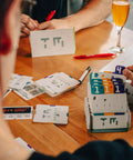Players engaging with Analog Logic Puzzle Game For Teens And Adults Break Codes With Punch Card Challenges And AI Style Logic Puzzles