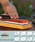 Person sharpening knife on Dual Sided Whetstone Knife Sharpening Kit with 400 1000 and 3000 8000 Grits Wet Stone Set, wooden base visible.