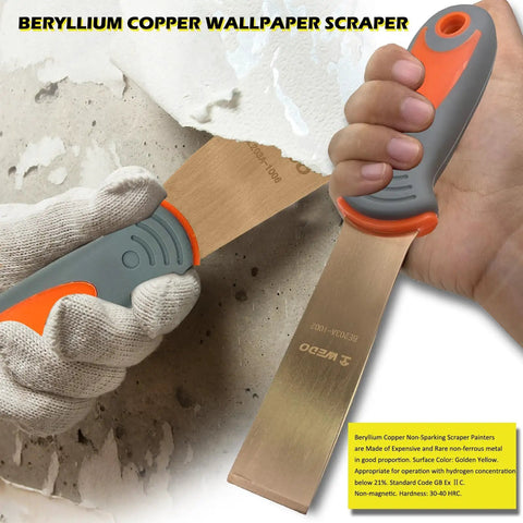 Beryllium copper wallpaper scraper held by a hand, non-sparking and non-magnetic, used for safe material removal.